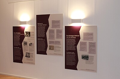 Drei Ausstellungstafeln hängen an einer Wand im "Geschichtsort Stadthaus"